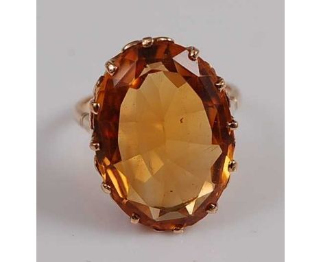 A yellow metal citrine dress ring, the oval citrine measuring approx 21.5 x 15.1 x 8.0mm, weight estimated as 16.68 carats, m