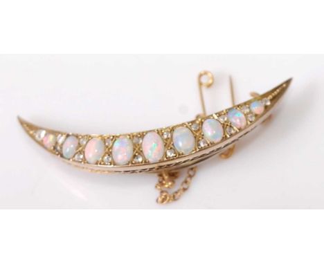 A late 19th century yellow metal, opal and diamond crescent brooch, featuring nine graduated oval opal cabochons interspersed