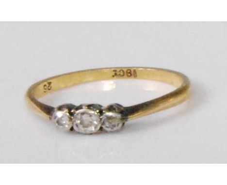 A circa 1920 18ct gold diamond three-stone ring, the graduated round cut illusion set diamonds weighing approx 0.2 carats in 