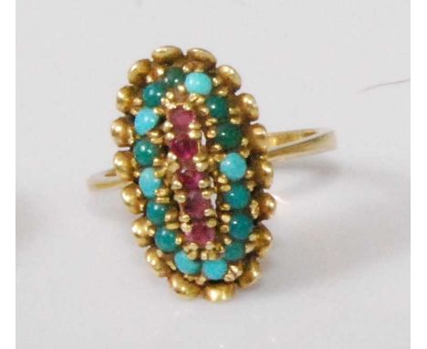 An 18ct gold, ruby and turquoise set dress ring, the large oval setting centre set with a row of five small round cut rubies 