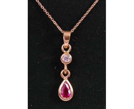 An 18ct yellow gold, ruby and diamond pendant, featuring a pear shaped ruby suspended from a round brilliant cut diamond, in 