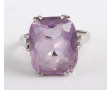 A modern 18ct white gold and amethyst set dress ring, the claw set cushion cut amethyst measuring approx 15 x 12.5 x 6.5mm, 5