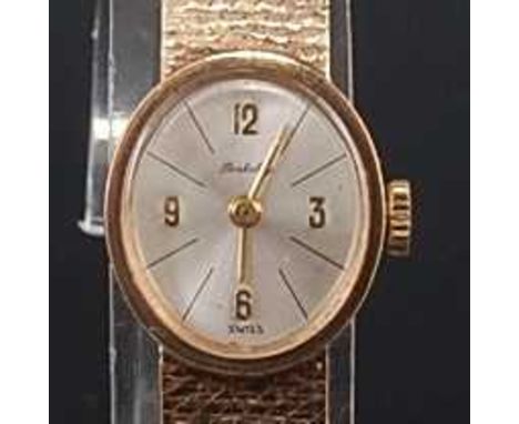 A ladies 9ct yellow gold Berkley manual wind wristwatch, having an oval silvered quarter Arabic dial and an integral Milanese