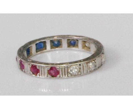 A white metal, ruby, diamond and sapphire set 'patriotic' eternity ring, arranged as four round cuts of each stone, each weig
