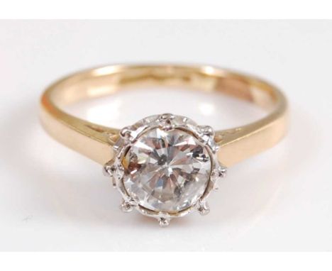 A yellow and white metal diamond single stone ring, featuring an Old European cut diamond in an illusion setting with pierced