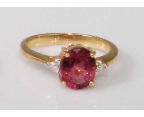 A contemporary 18ct gold, pink topaz and diamond point dress ring, the four claw set oval cut topaz weighing approx 1.75 cara