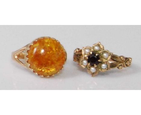 A 9ct gold cabochon amber set dress ring, 2.5g, size K; together with a 9ct gold garnet and seed pearl set flowerhead cluster