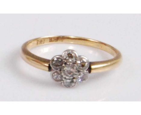 A circa 1920s 18ct gold diamond cluster ring, arranged as seven round cut diamonds in a flower head setting, 2.5g, sponsor FJ