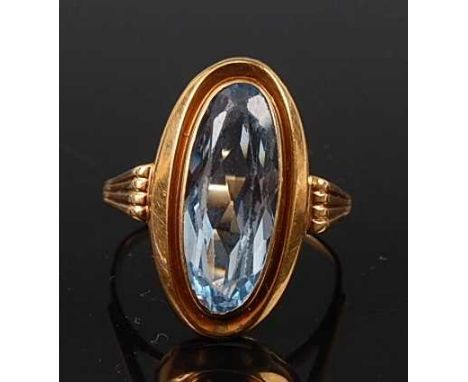 A yellow metal single stone synthetic spinel dress ring, comprising an oval faceted synthetic spinel measuring approx 19.6 x 