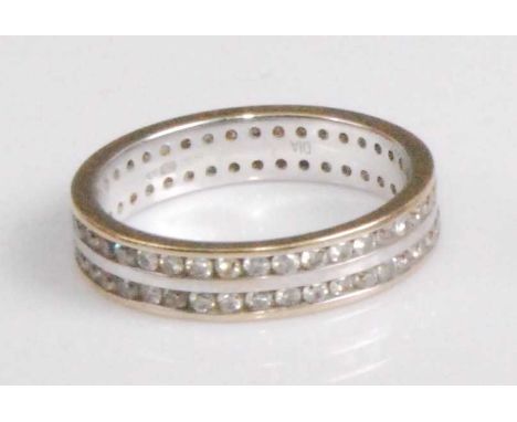 A contemporary 18ct yellow and white gold diamond eternity ring, arranged as two rows of channel set small brilliants, 3.5g, 