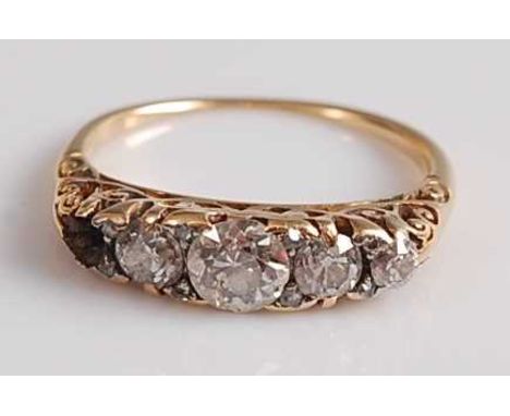 A late Victorian yellow metal diamond five stone half-hoop eternity ring, featuring four graduated Old European cut diamonds 