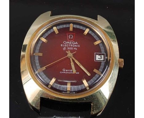 A Gents gold plated Omega electronic chronometer watch, having a round red baton dial with date aperture, movement reference 