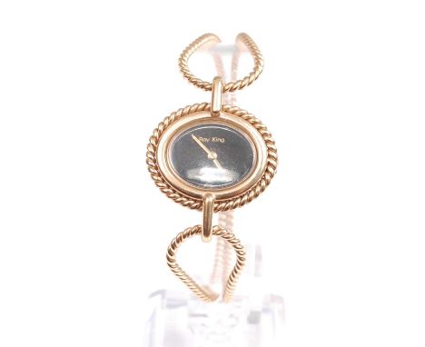 A 9ct yellow gold Roy King seventeen jewel manual wind lady's wristwatch, having an oval black dial and rope edge bezel, fitt