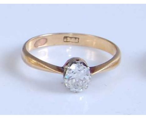 A yellow and white metal diamond solitaire ring, featuring an oval cut diamond in an eight claw setting, diamond dimensions a