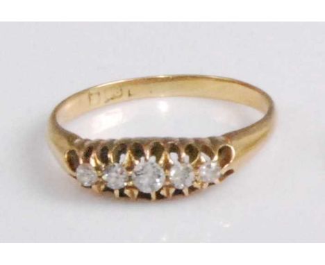 An 18ct gold diamond five-stone ring, the graduated old cut diamonds in a line setting, the centre stone weighing approx 0.1 