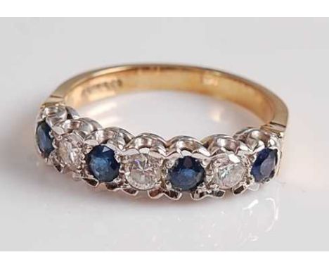 An 18ct yellow and white gold, sapphire and diamond seven stone half-hoop eternity ring, featuring four round faceted sapphir