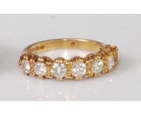 A contemporary 18ct gold diamond seven stone half eternity ring, the brilliants each weighing approx 0.14 carats, 3.7g, size 