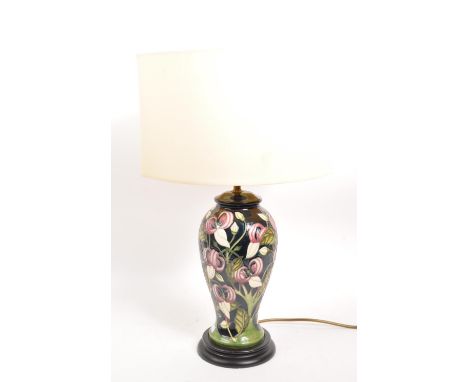 Moorcroft - A mid century ceramic pottery Moorcroft lamp. Having a white shade, light fixing to top, traditional style taperi