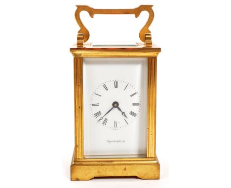 An original Mappin &amp; Webb brass cased carriage mantel clock set within bevelled glass panel sides with black roman numera