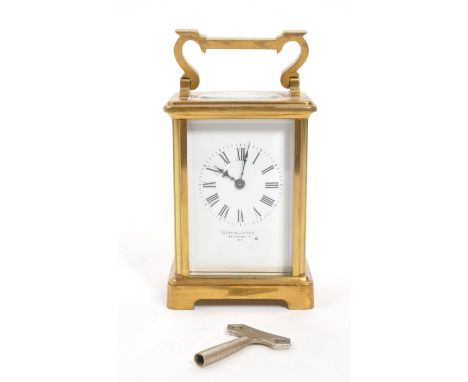 Mappin Brothers - Early 20th century French brass carriage / mantel clock. Carry handle to top, white face with ebonised chap