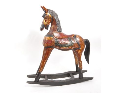 A 20th century folk art painted carved wooden rocking horse. The rocking horse having small proportions, raised on ebonised r