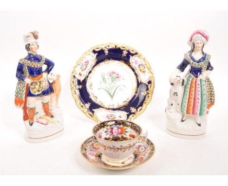 Staffordshire - A pair of 19th Century ceramic Staffordshire figurines comprising of a male figure with dog and a female figu