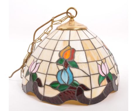 Tiffany Manner - A vintage 20th century hanging ceiling light shade. Circular tapering form with coloured glass floral panels