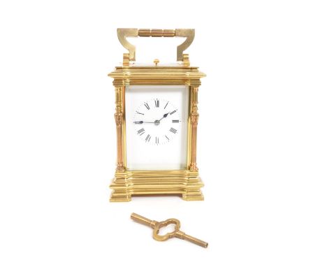 A vintage mid century large brass carriage clock. Having a carry handle to top, a white enamelled face with an ebonised Roman