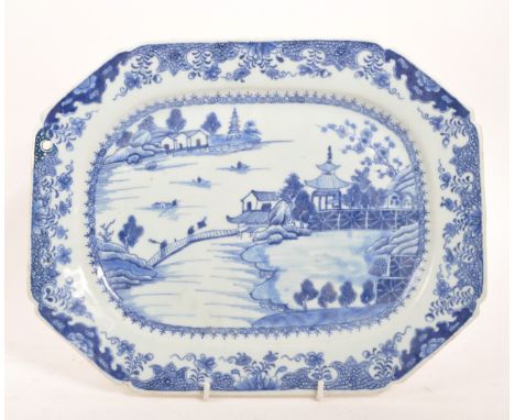 An 18th Century ceramic Chinese blue and white plate portraying oriental scene of lake, bridges, cherry blossom, and pagoda b