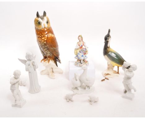 A collection of German ceramic item to include a lady figurine by Sitzendorf. Also comprising of a large owl perched on branc