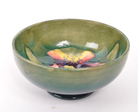 Moorcroft - Early 20th century ceramic pottery Orchid dish / bowl. Green and blue ground with W Moorcroft signature.11cm diam