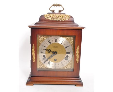 St James - A vintage 20th century mantel clock. Gilt face with ebonised Roman numeral chapter ring. Three chimes including We
