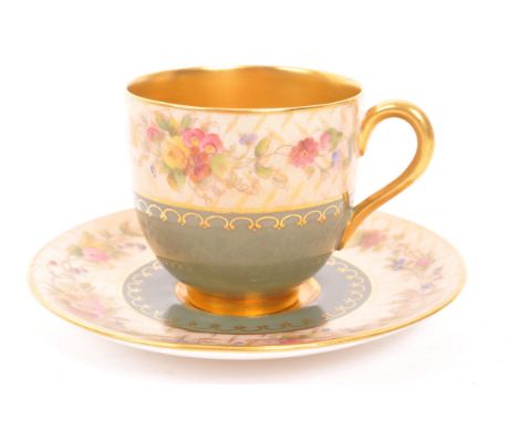 An early 20th Century 1930s Royal Worcester gold plated cup and saucer with olive green and floral decoration. Cup measures a