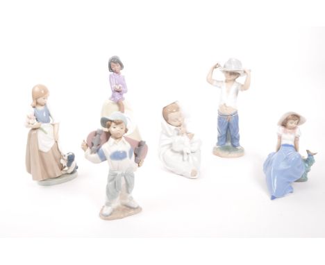 Nao for lladro - A collection of six 20th century Spanish porcelain figurines to include boys and girls playign with cats bir