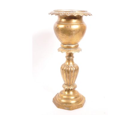 A 20th century brass jardiniere plant stand. The stand having a stepped base, with gadrooned relief to central column. Featur