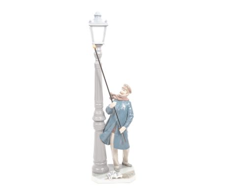 Lladro - A vinatge 20th century Spanish porcelain Lladro lamp lighter figurine. The figurine being modelled in the form of a 