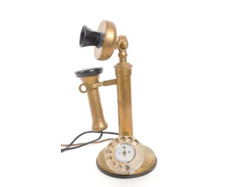 A vintage brass and Bakelite candlestick telephone with rotary dial and hook with ear piece. Measures approx 33cm.