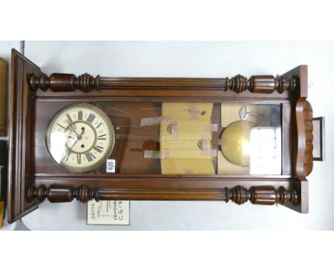 A 19th Century Vienna Clock with Enamel Face marked with mark for the clockmaker Geo Kuehl. Some wear and warping to wood. He