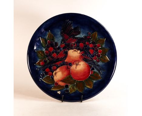 Moorcroft large charger decorated in the Finch and Berries design on dark blue ground, C1990, d.35cm. Some all over light cra