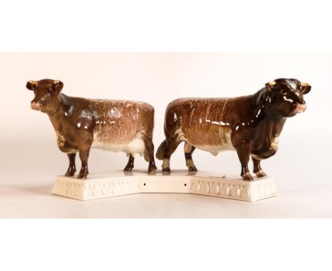 Beswick Dairy Shorthorn bull and cow mounted on ceramic base 1863. 'Presented by Dairy Farmer magazine' to base. Both horn ti