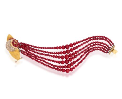 AN AGATE, RUBY AND DIAMOND BRACELETComposed of six strands of graduated red agate beads, to a clasp designed as a realistic s