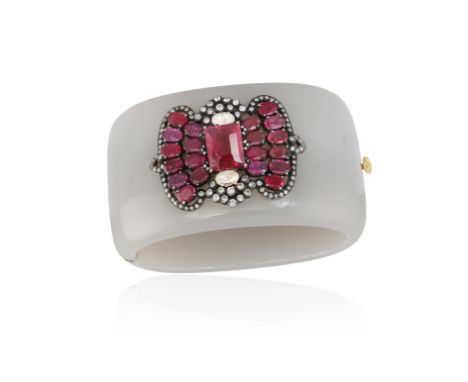 A BAKELITE, TOURMALINE AND DIAMOND BANGLE BRACELET The hinged broad polished grey bakelite bangle, with central bow motif set