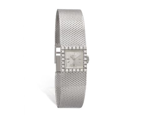 MARVIN: A LADY'S 18K GOLD & DIAMOND-SET COCKTAIL WATCH, CIRCA 1960Of manual wind movement, the square silvered dial with appl