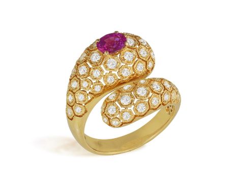 A DIAMOND AND RUBY DRESS RING Of crossover openwork design, composed of hexagonal-shaped motifs set with brilliant-cut diamon