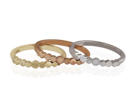 MIRIAM WADE: THREE GOLD RINGSEach designed to the front with alternating polished circular- and oval-shaped motifs, to a plai