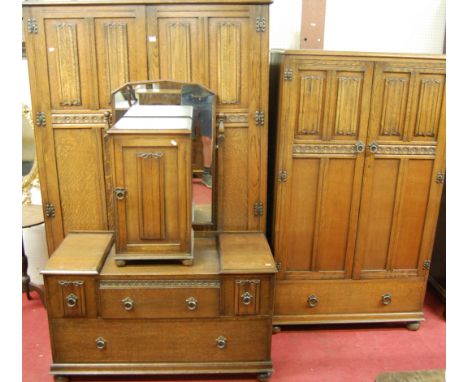 A suite of moulded linenfold oak bedroom furniture, to include; large double door wardrobe, small double door wardrobe (with 