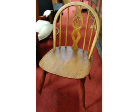 A set of four Ercol mid-elm stickback kitchen chairs