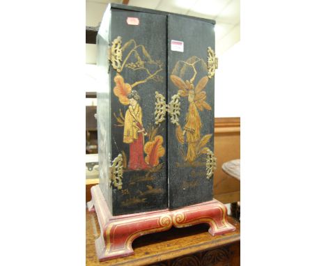 An early 20th century Japanese black lacquered table-top double door curiosity cabinet, decorated with figures within a gilt 