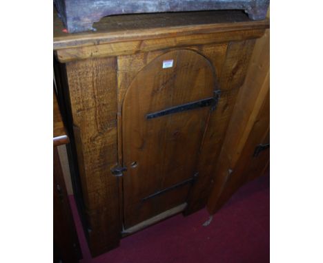 A contemporary planked and stained pine single door side cupboard, having exposed iron hinges, w.68.5cm
