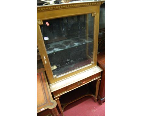 A French gilt decorated single door glazed display cabinet, raised on base fitted with single central frieze drawer over squa